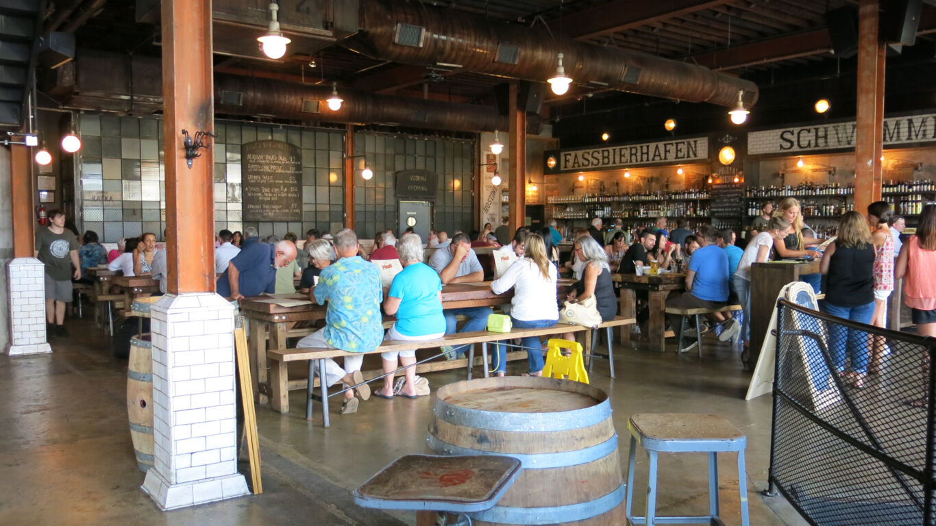 Customers enjoying drinks at Asbury Biergarten inside